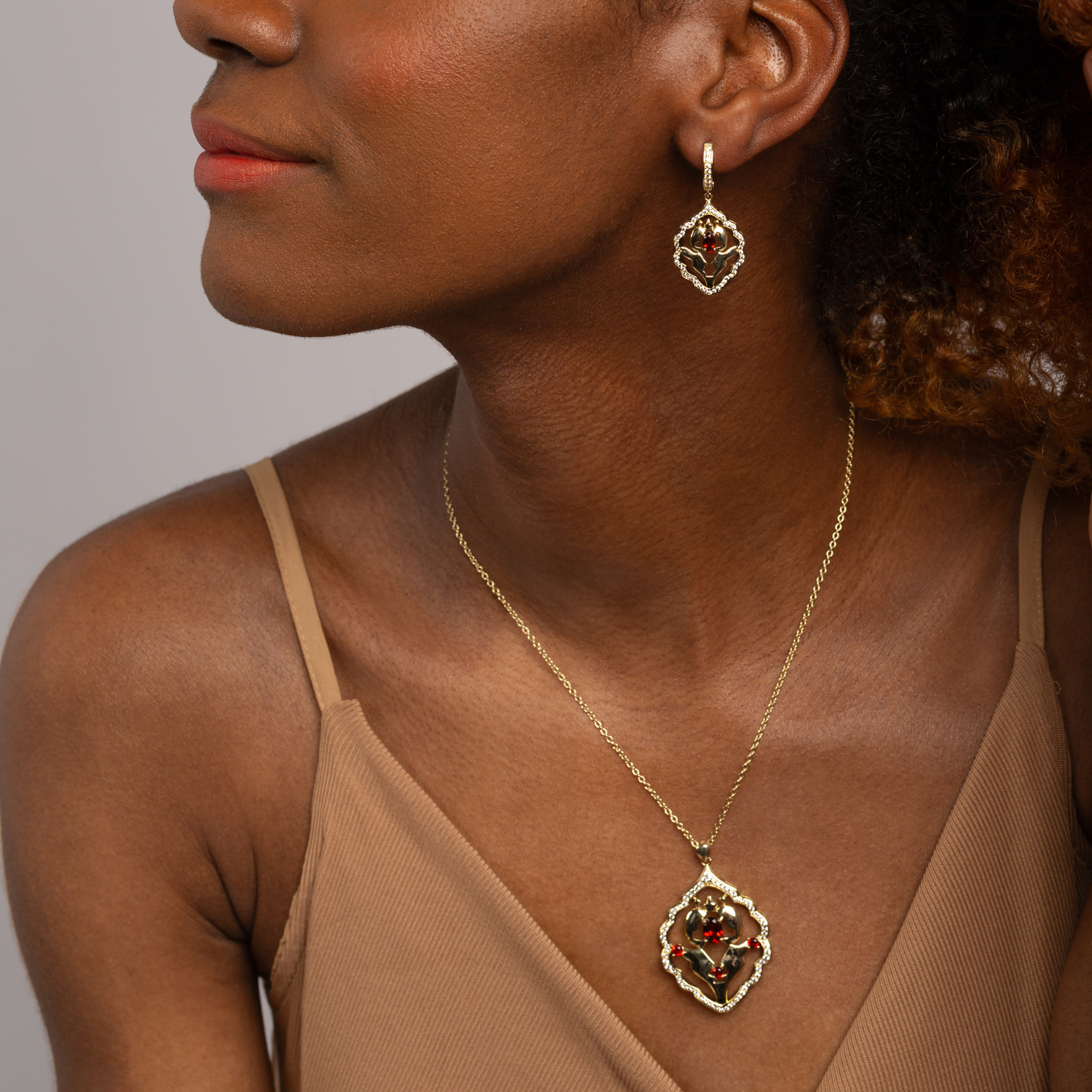 Model wearing 18k gold plated 925 sterling silver garnet necklace with cubic zirconia accents