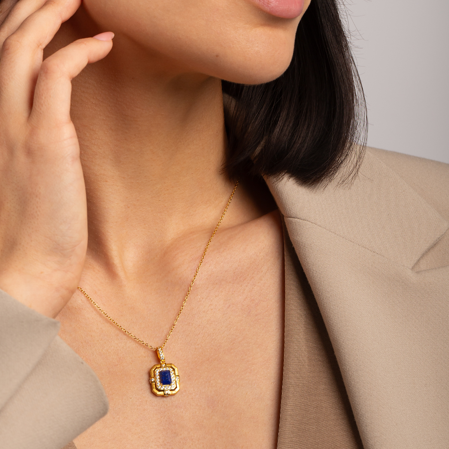 Model wearing 18k gold plated 925 sterling silver lapis lazuli necklace symbolising strength and confidence