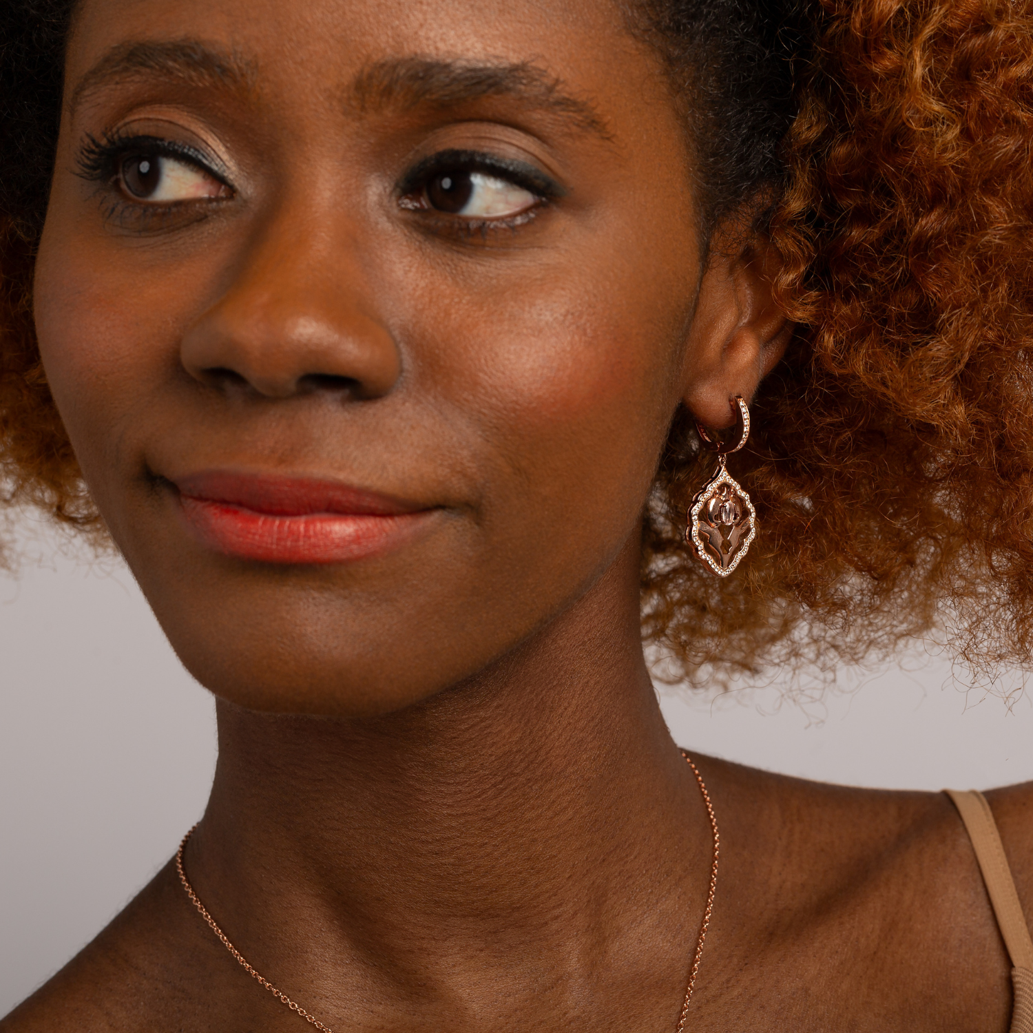 Model wearing 18k rose gold plated 925 sterling silver rose quartz earrings