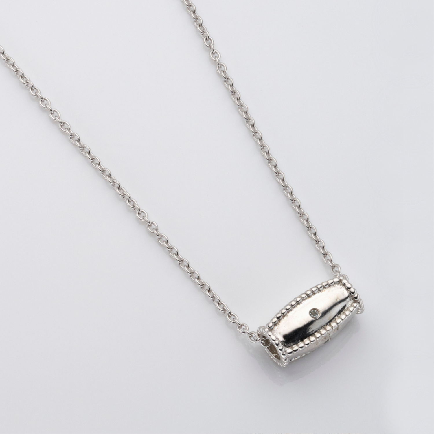 rhodium plated sterling silver blue topaz barrel pendant