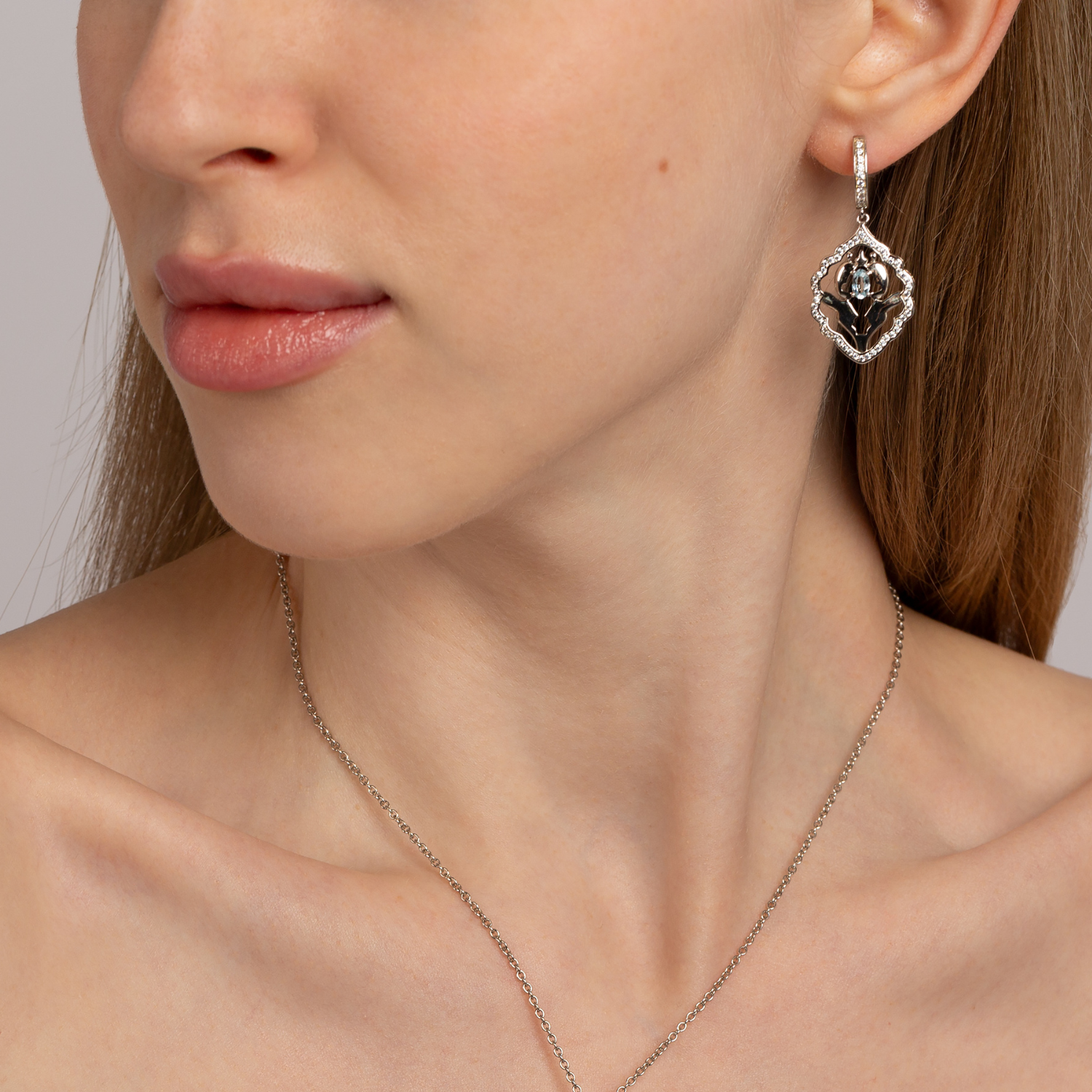Model wearing 925 sterling silver blue topaz Iznik earrings