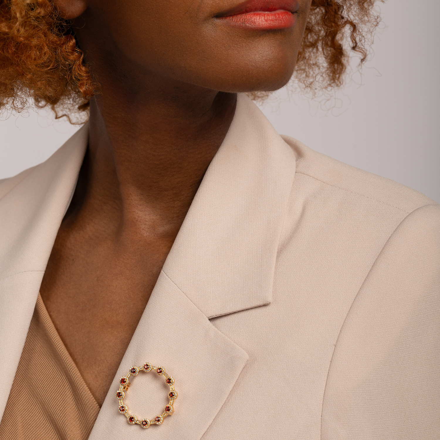 model wearing 18k gold 925 sterling silver garnet brooch