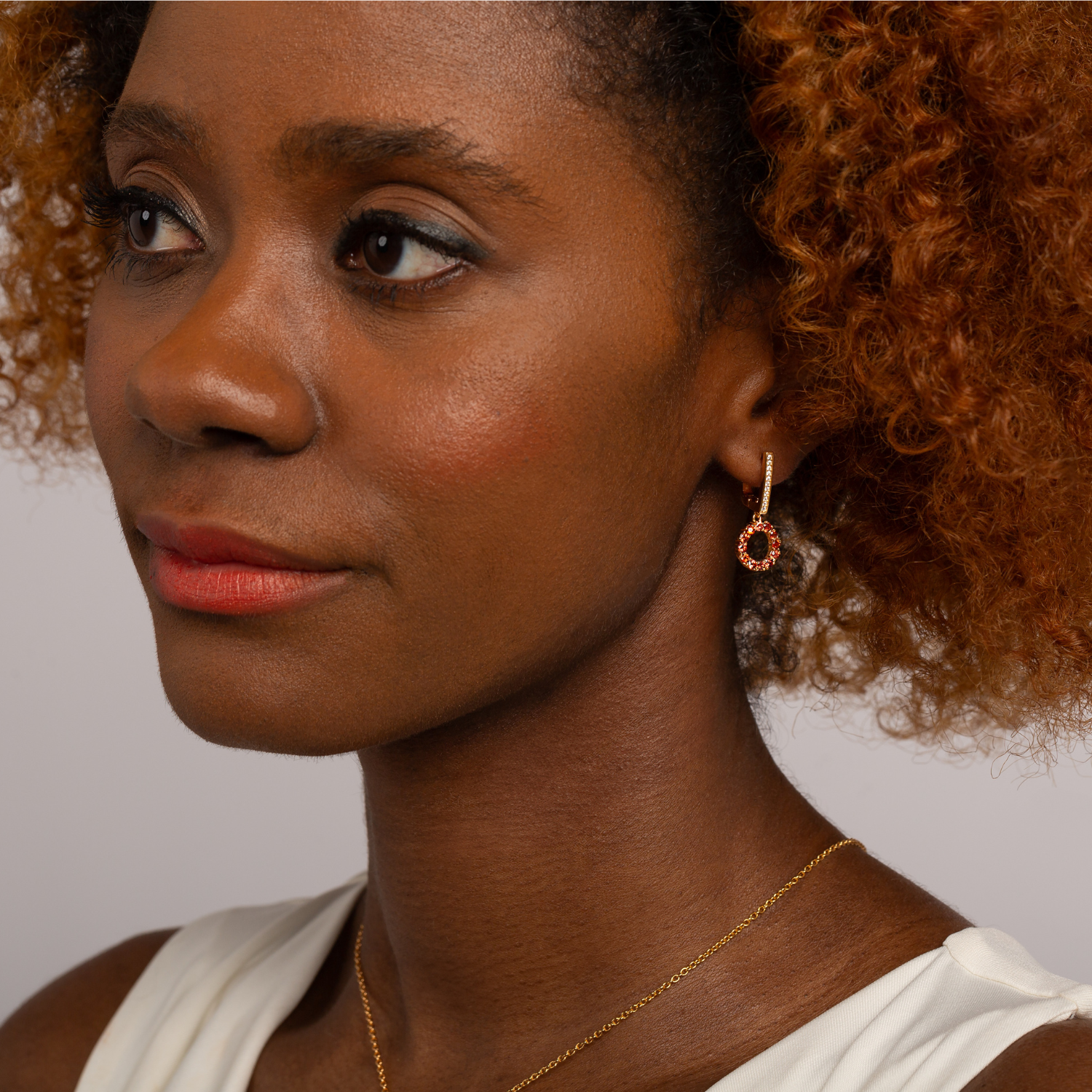 model wearing 18k gold 925 sterling silver garnet drop earrings