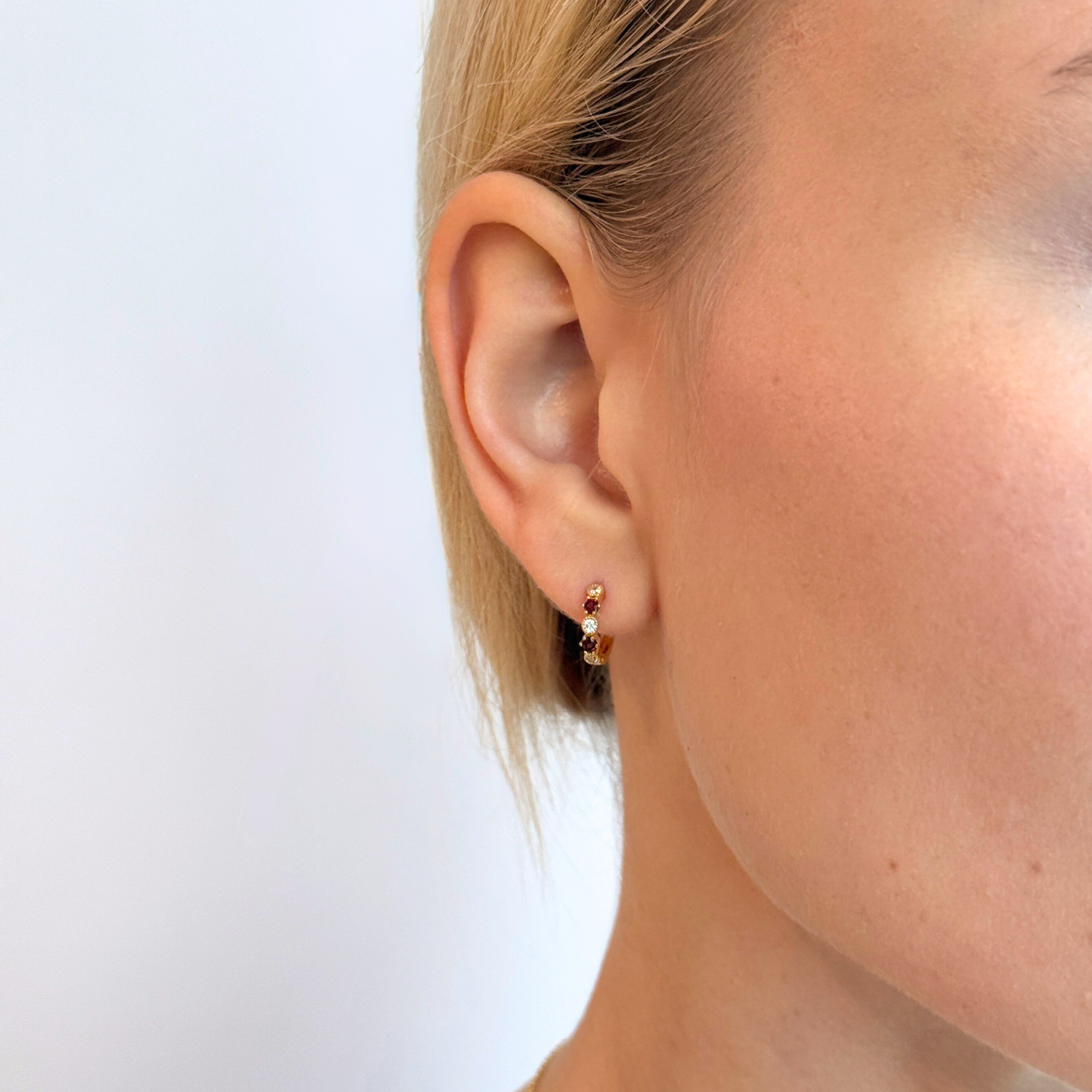 model wearing 18k gold 925 sterling silver garnet hoops