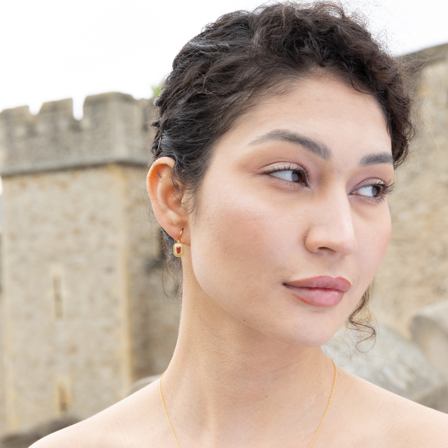 model wearing 18k gold plated sterling silver garnet orb earrings