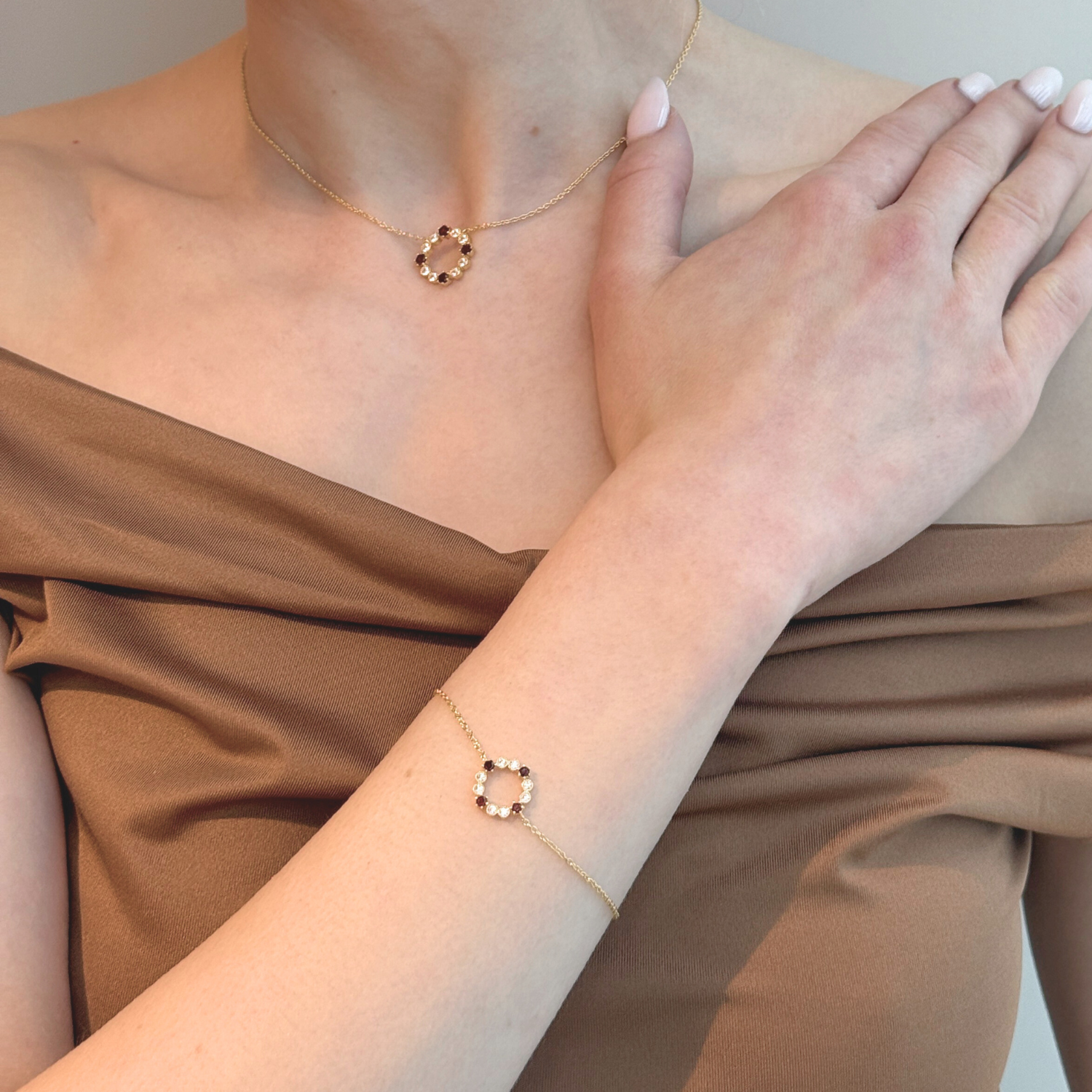 model wearing 18k gold 925 sterling silver garnet round bracelet