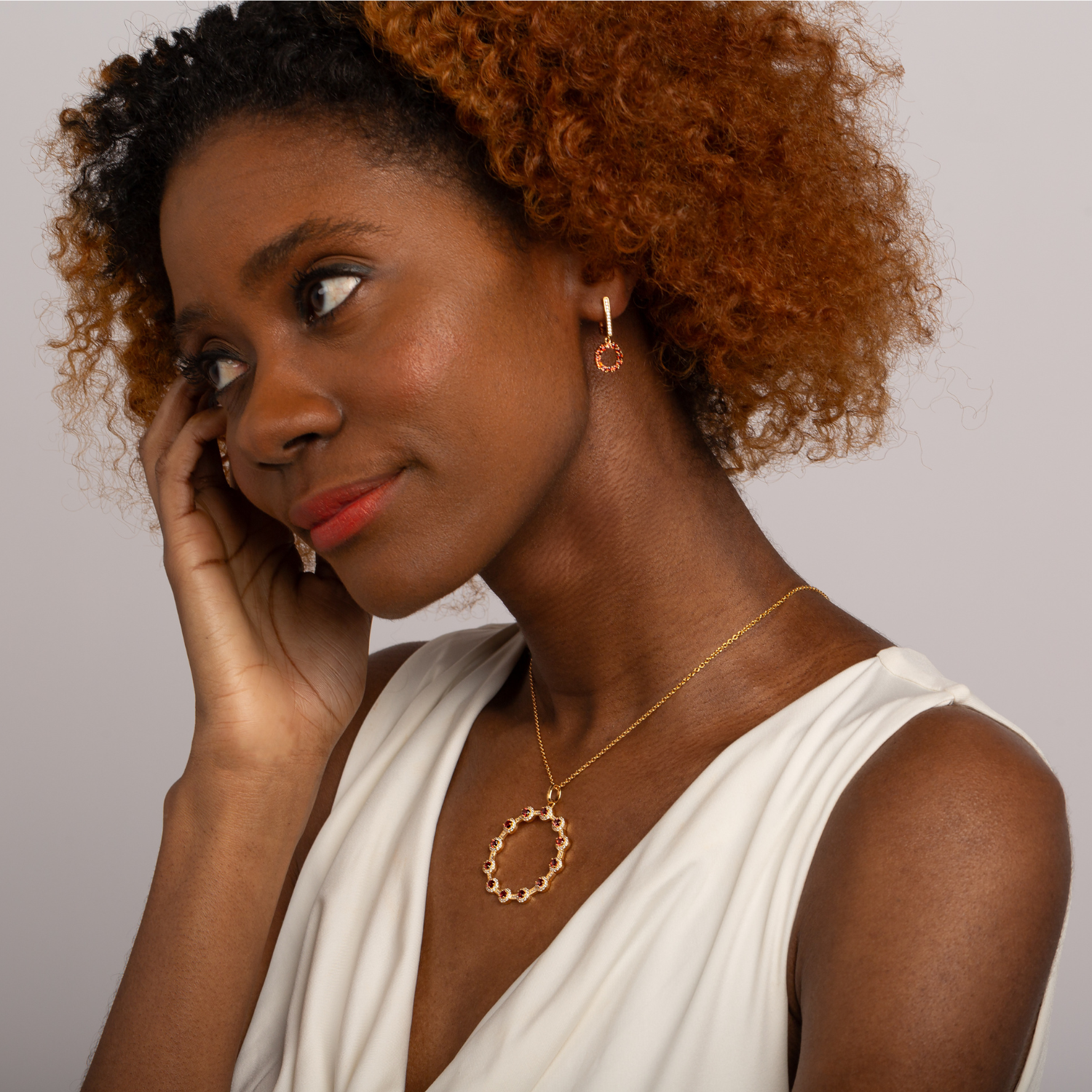 model wearing gold garnet statement necklace