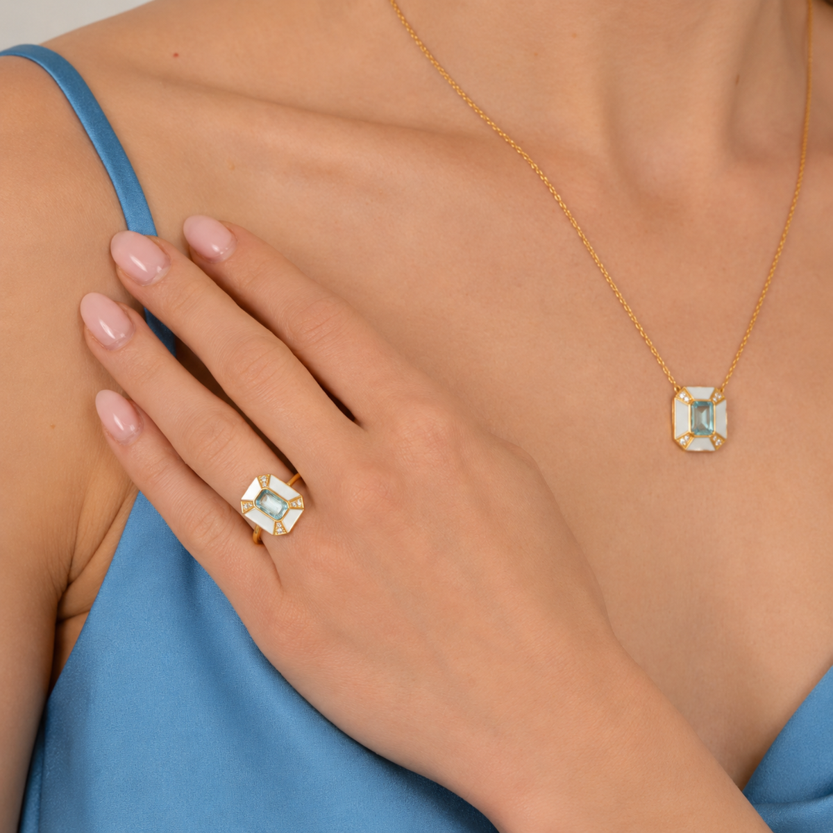 model wearing 18k gold plated sterling silver pearl blue topaz aphrodite jewellery set