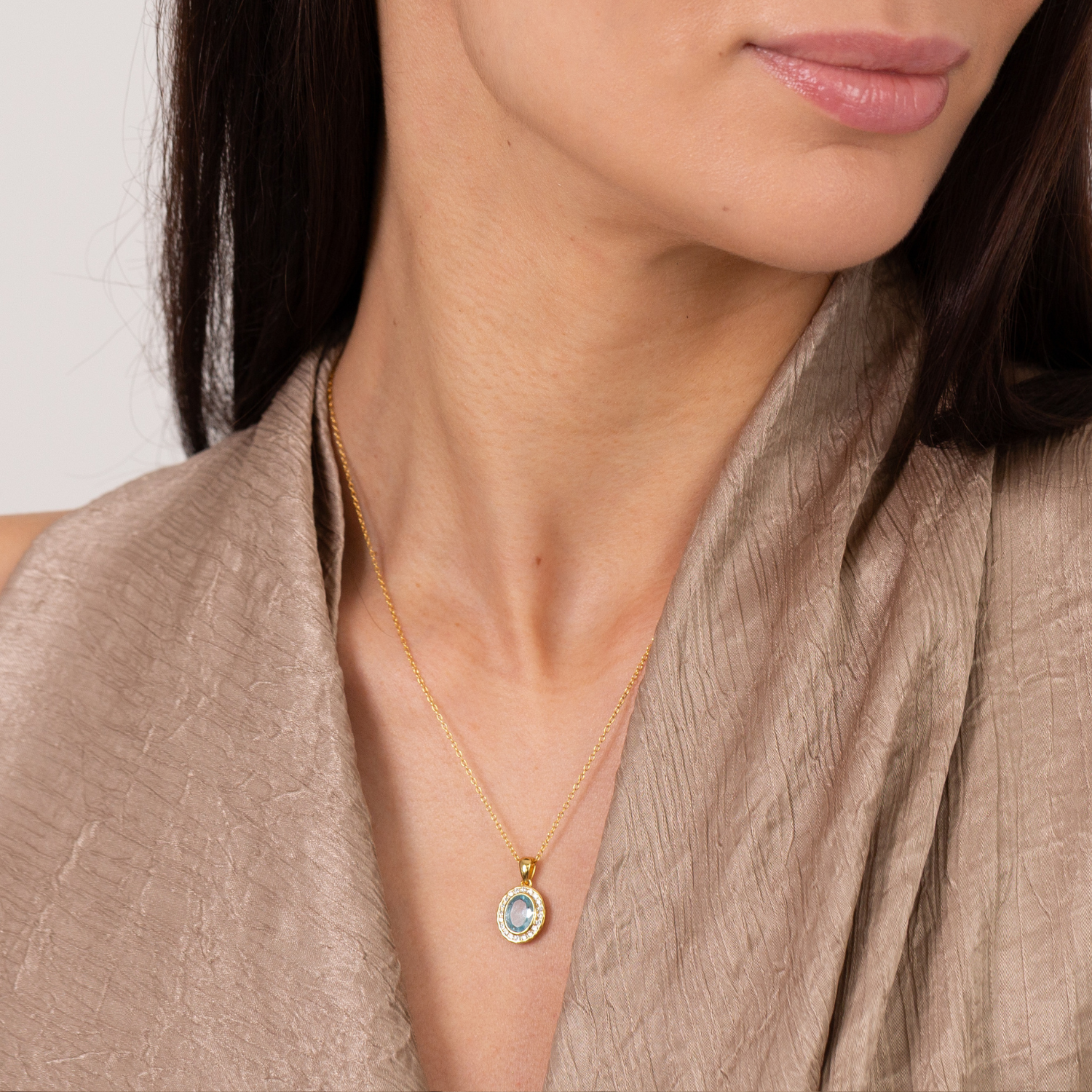 model wearing 18k gold blue topaz cubic zirconia halo necklace