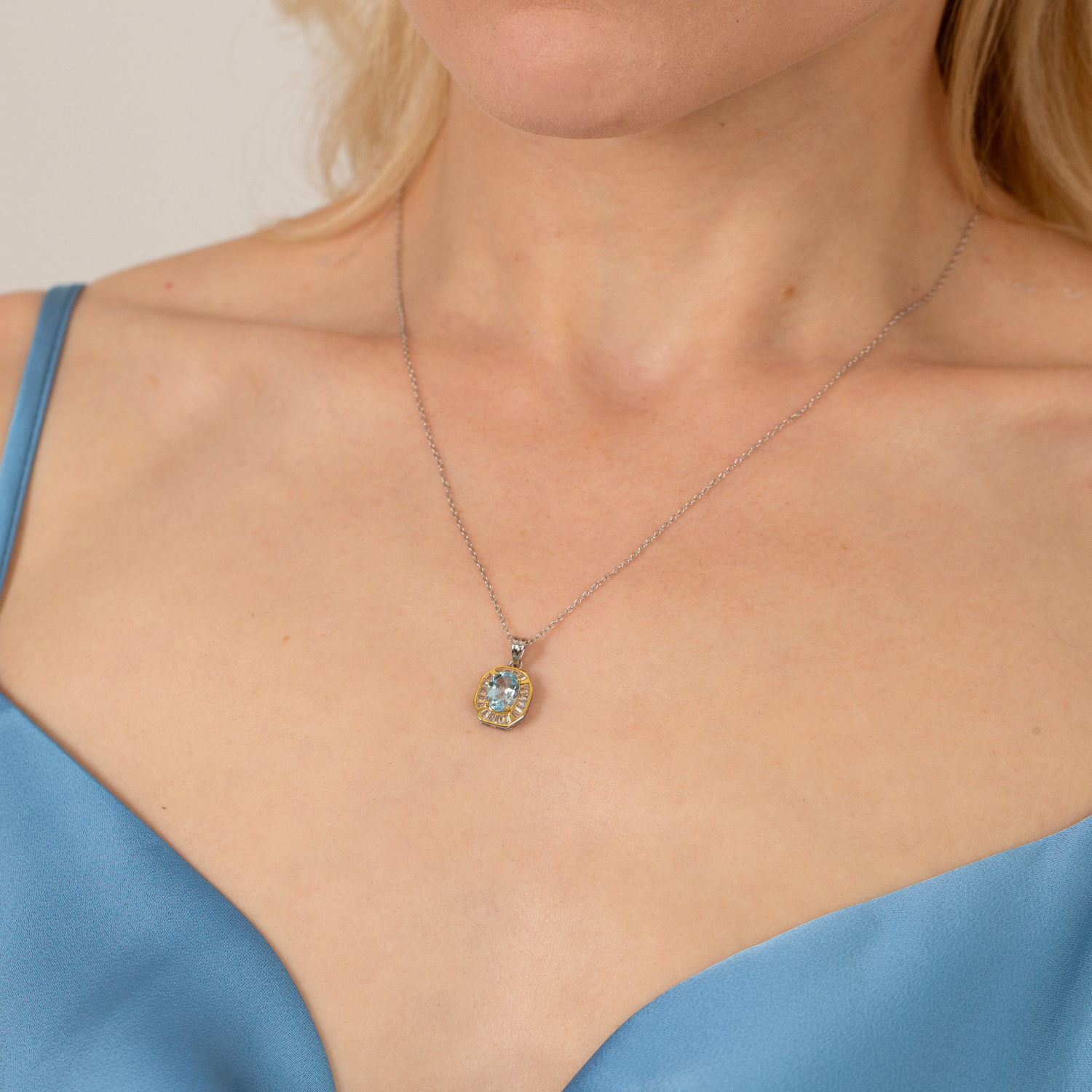 model wearing 18k gold plated sterling silver octagon shape blue topaz necklace