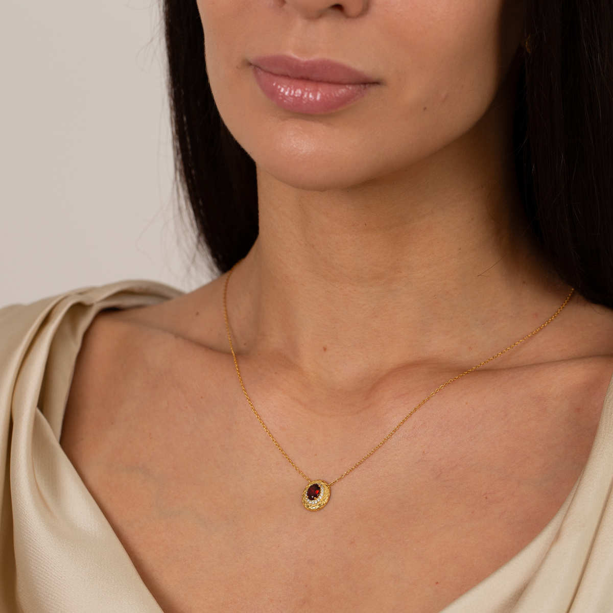 model wearing 18k gold plated sterling silver garnet halo necklace