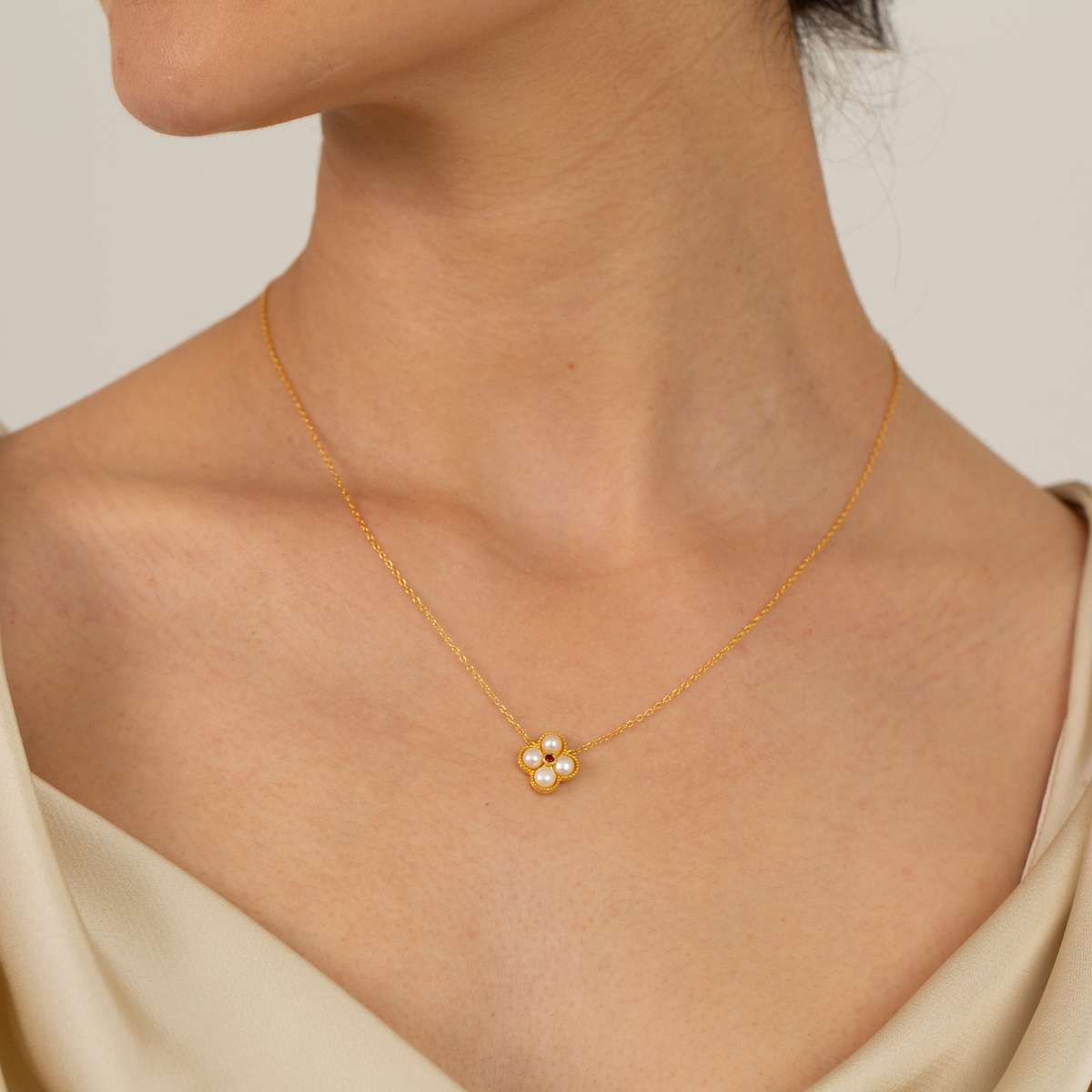 model wearing 18k gold plated sterling silver pearl garnet floral necklace