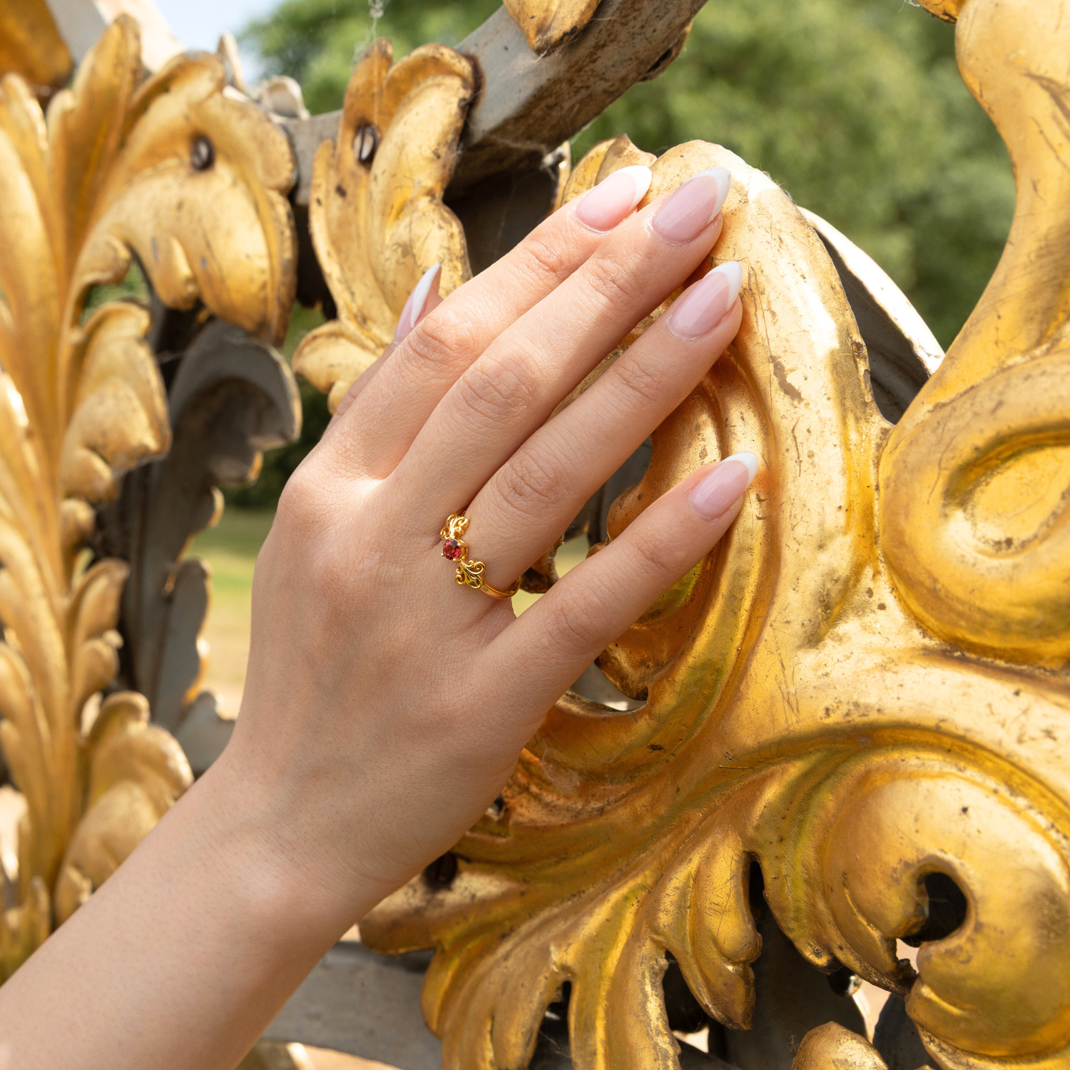 model wearing 18k gold plated sterling silver garnet tijou ring
