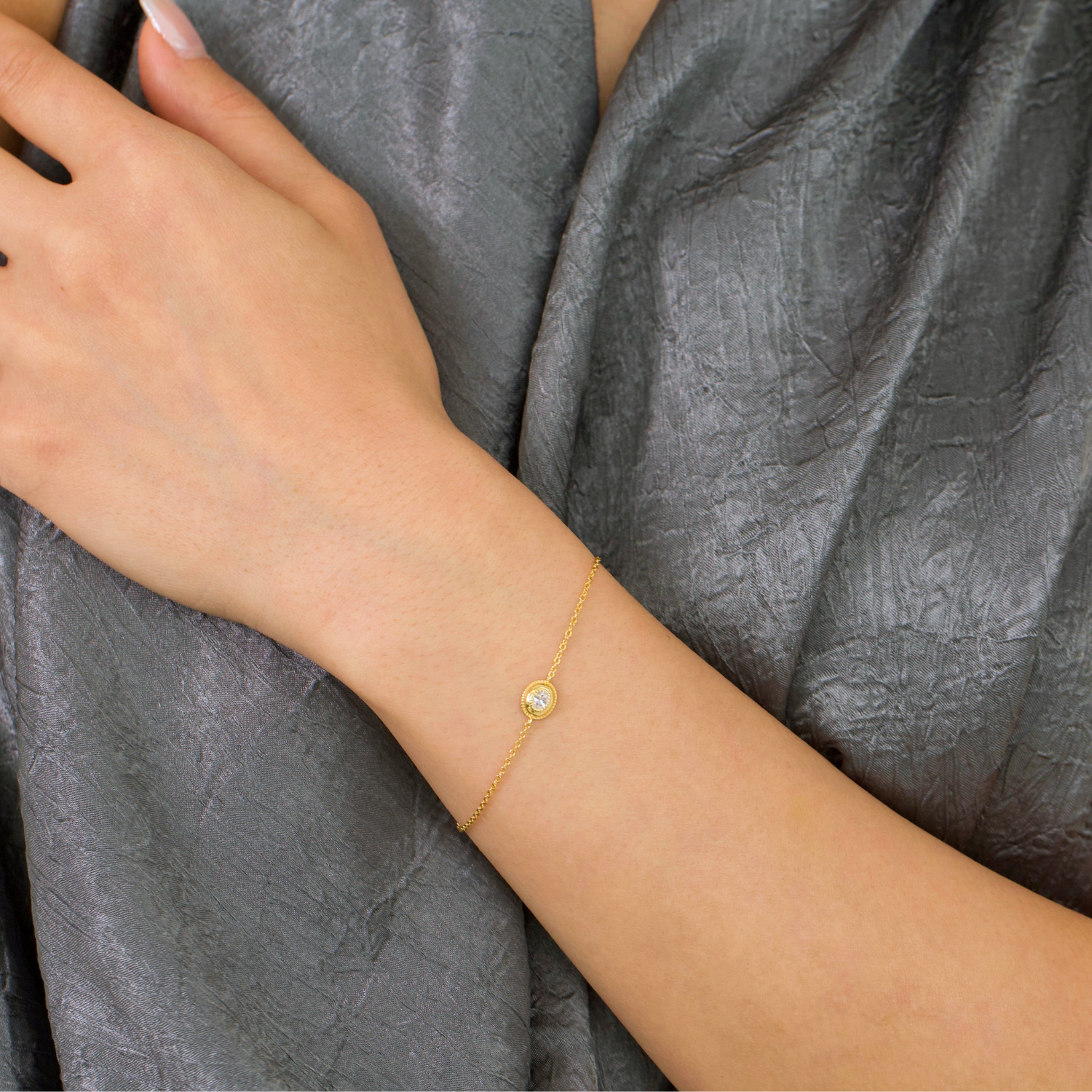 model wearing 18k gold plated sterling silver oval cubic zirconia bracelet
