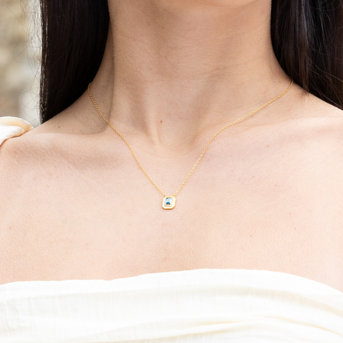 model wearing 18k gold plated sterling silver synthetic sapphire necklace
