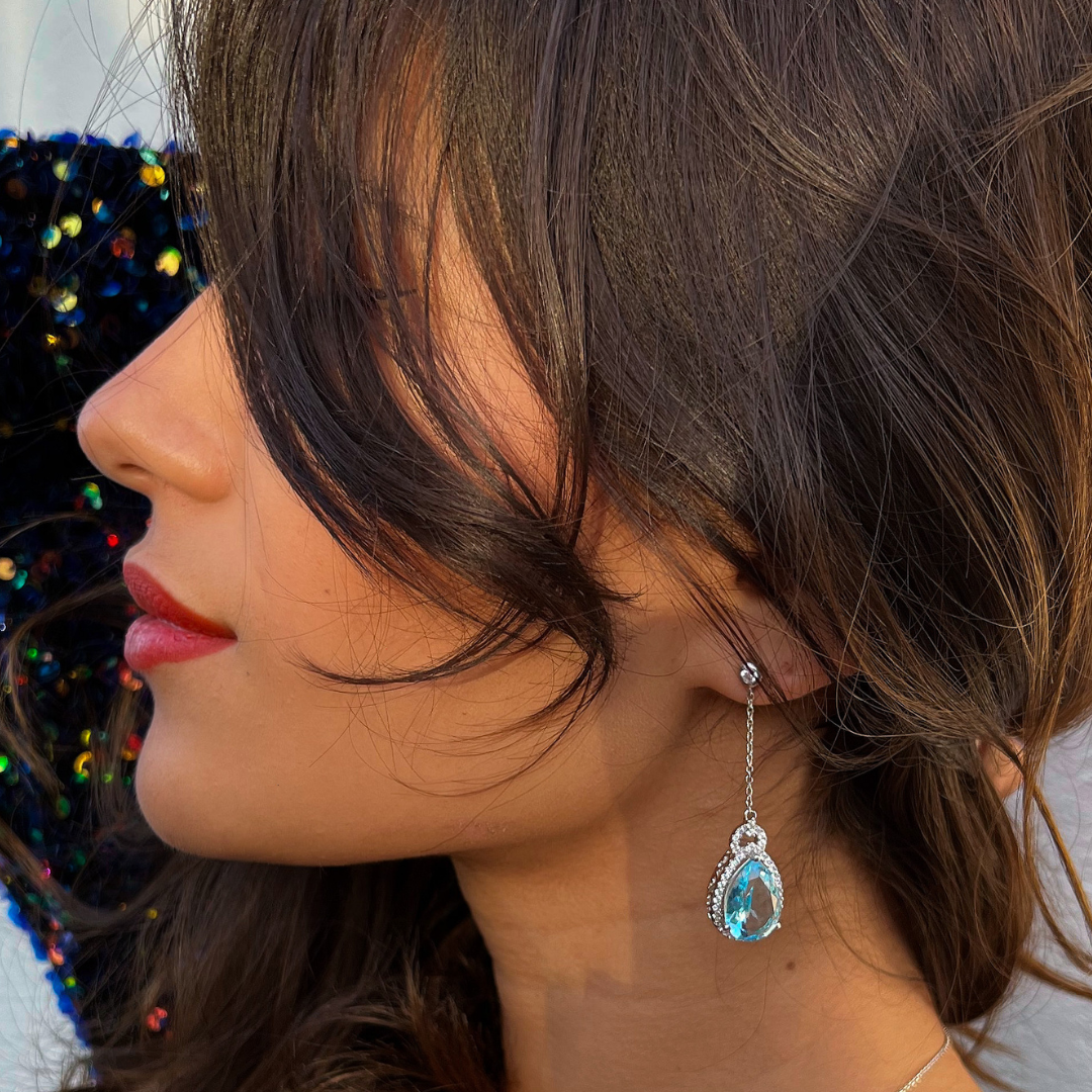 moel wearing 925 sterlings silver pear drop long drop blue topaz earrings