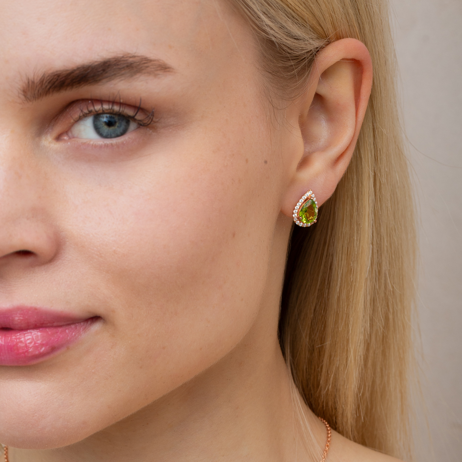 model wearing 18k rose gold plated 925 sterling silver pear drop peridot stud earrings