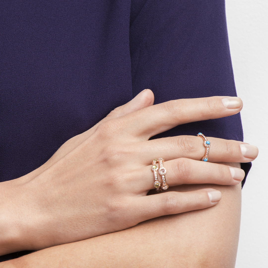 model wearing 18k rose gold plated 925 sterling silver stacking stone peridot ring