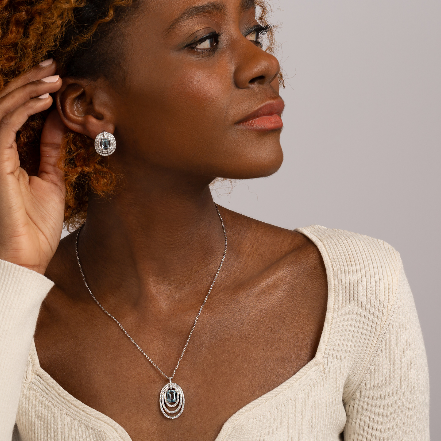 model wearing 925 sterling silver blue topaz statement earrings
