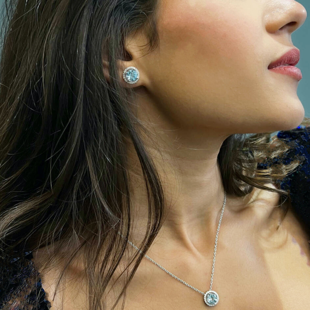 model wearing 925 sterling silver blue topaz stud earrings