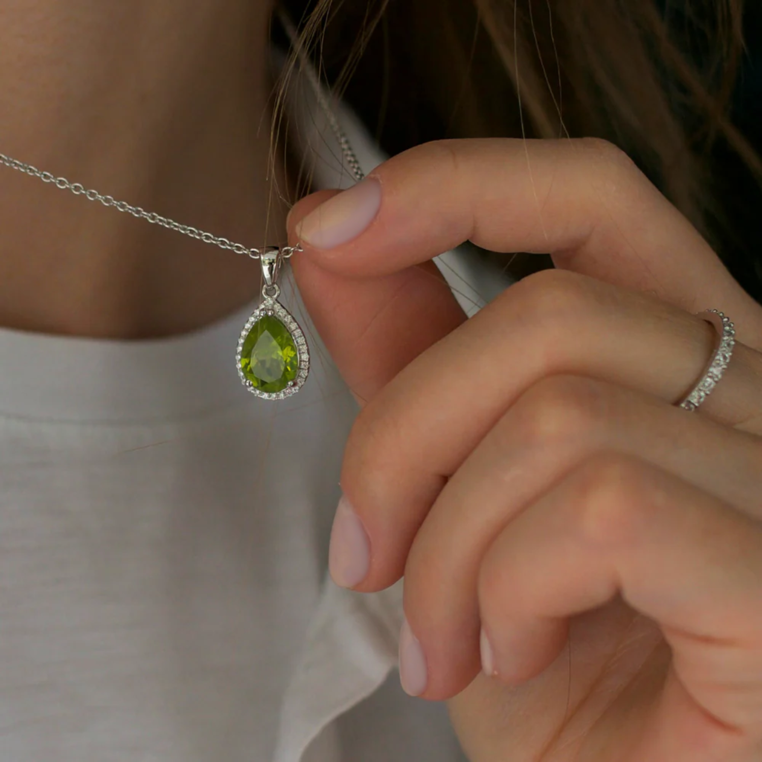 model wearing 925 sterling silver pear drop peridot necklace