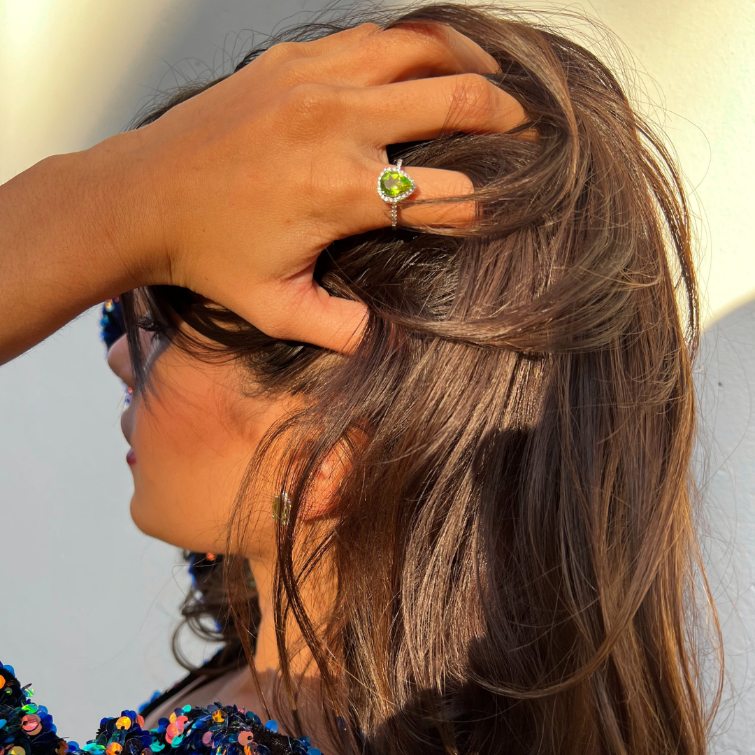 model wearing 925 sterling silver pear drop peridot ring