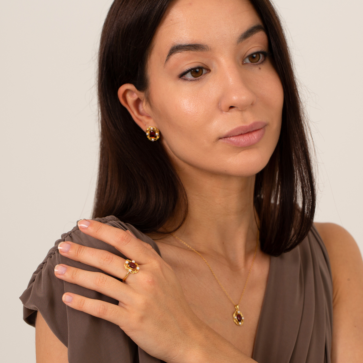 model wearing 18k gold plated sterling silver garnet pearl oval jewellery set