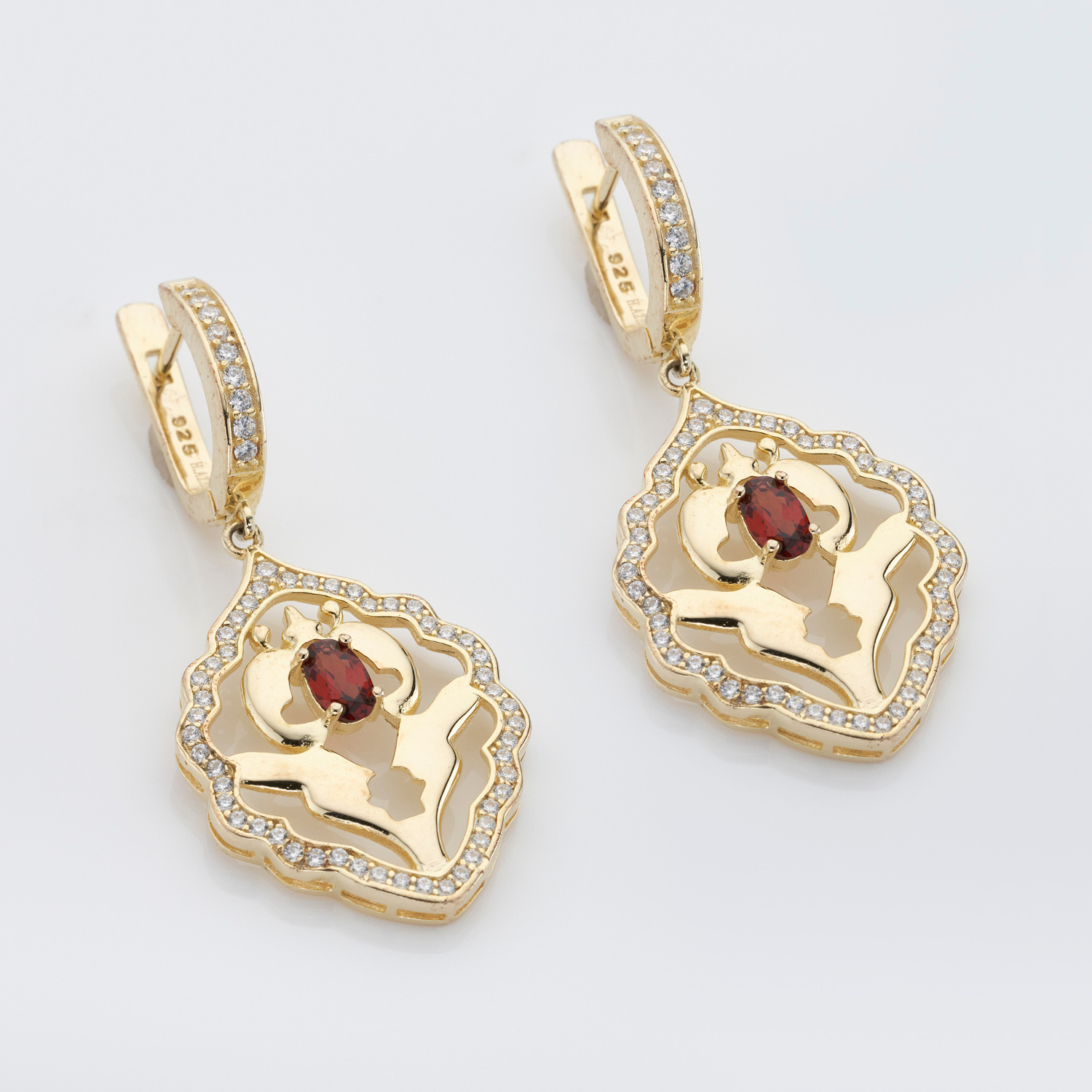 A pair of 18k gold plated sterling silver garnet earrings with cubic zirconia accents