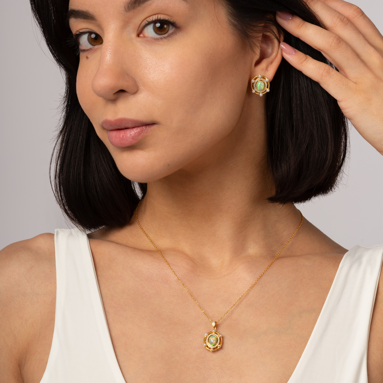 Model wearing 18k gold plating 925 sterling silver necklace with a pendant featuring an oval Opal surrounded by freshwater Pearls. Design inspired by Greek Goddess Hera