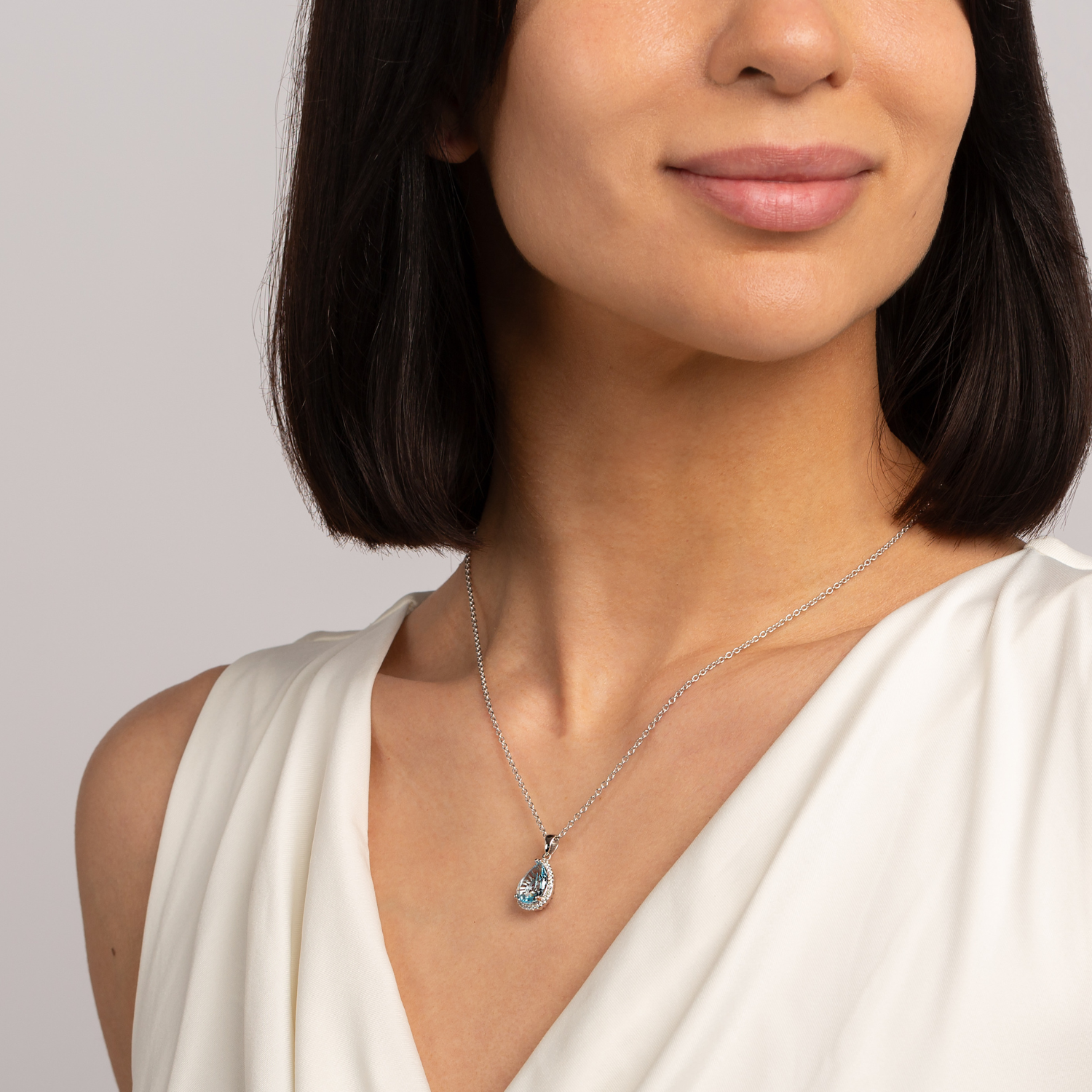 Model wearing 925 sterling silver pear drop blue topaz necklace