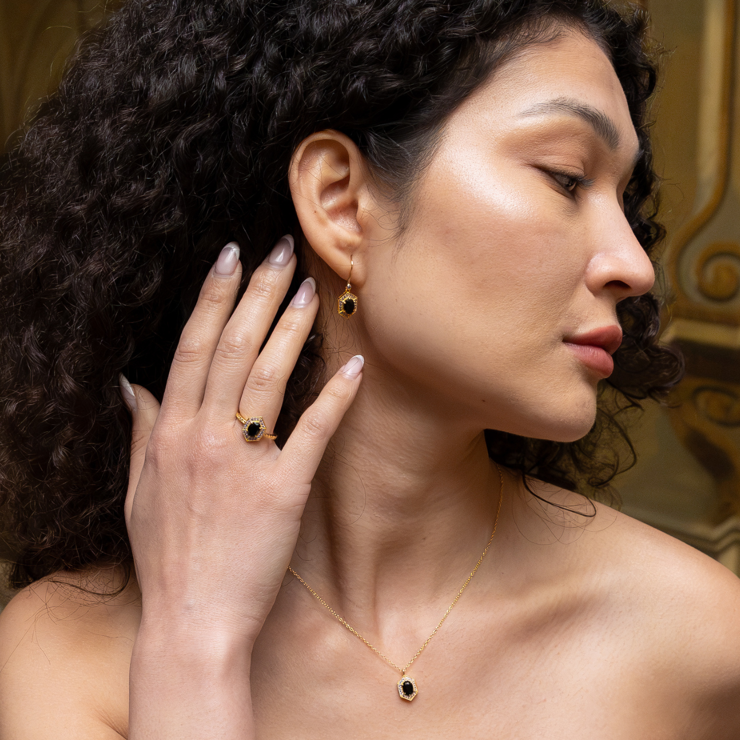 model wearing 18k gold plated sterling silver agate gemstone ring purple cubic zirconia
