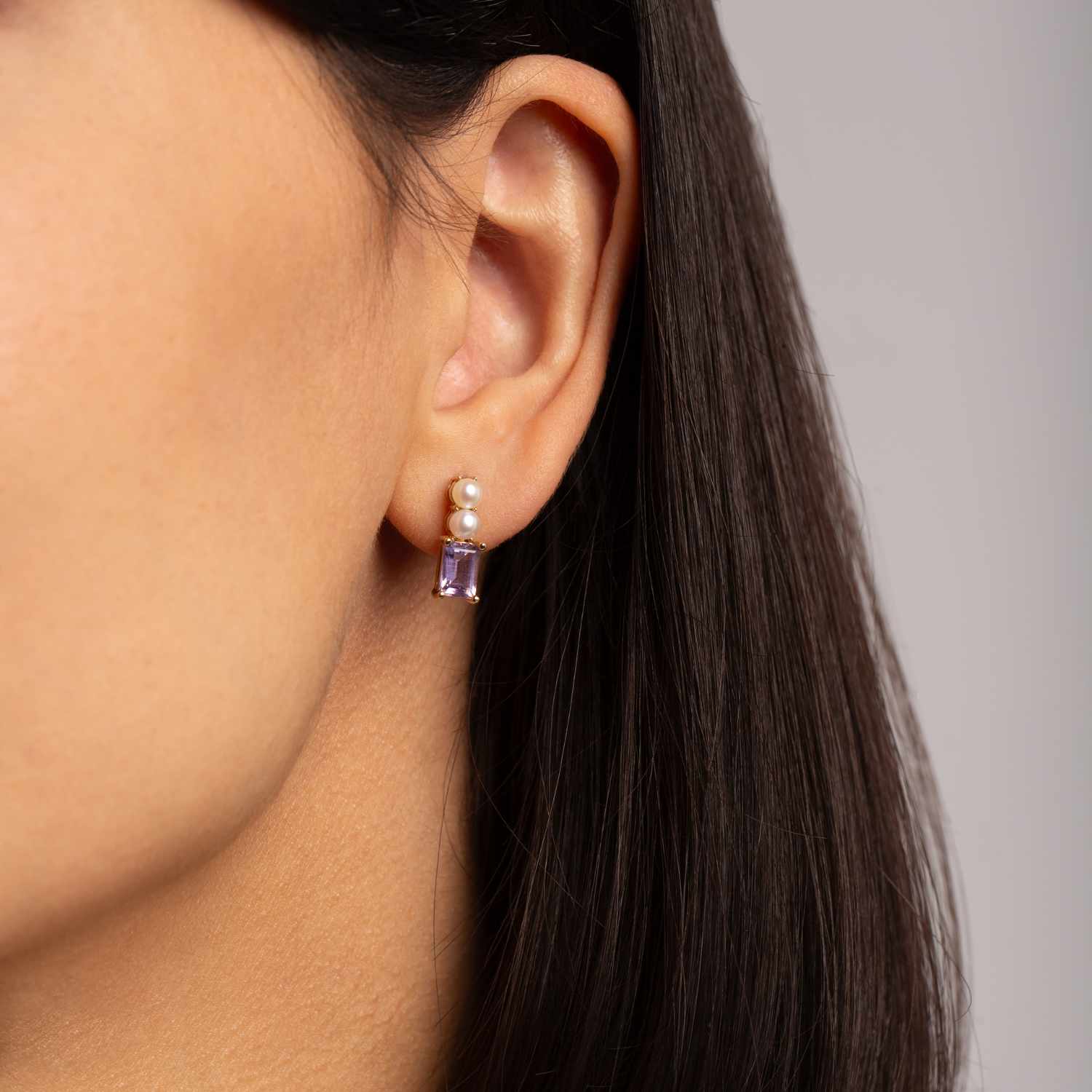 model wearing 18k gold 925 sterling silver amethyst pearl stud earrings