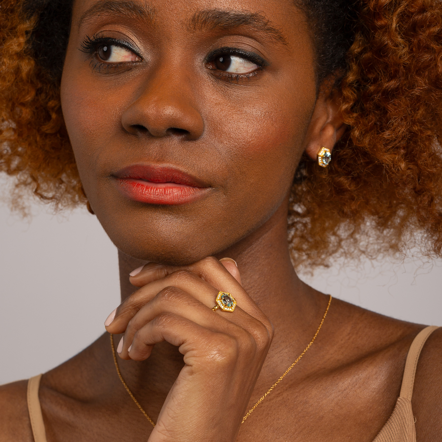 model wearing 18k gold plated 925 sterling silver blue topaz hexagon ring