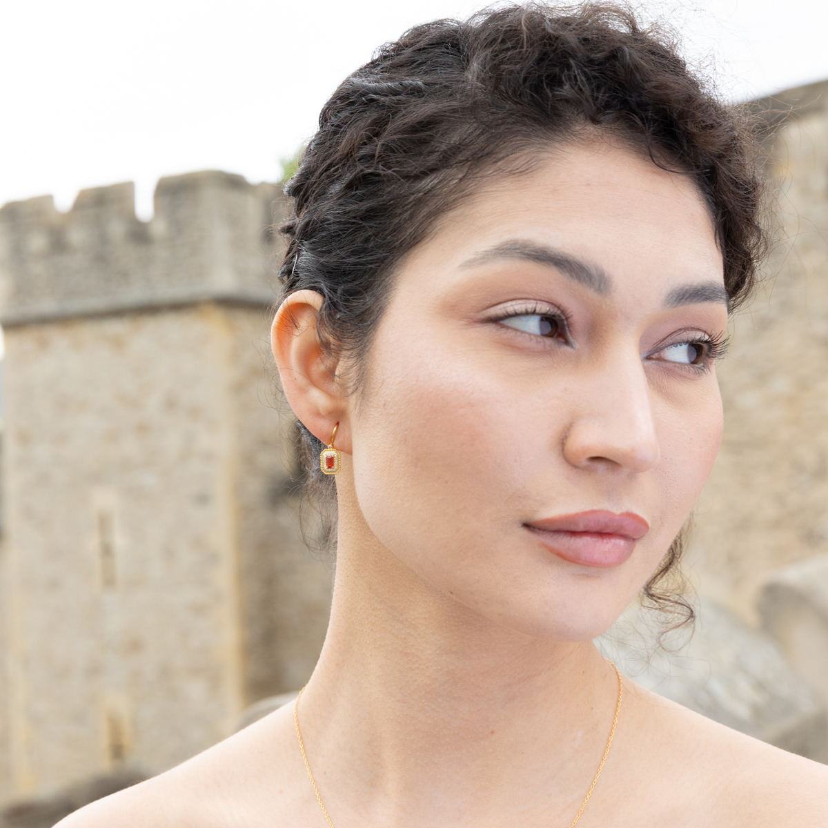 model wearing 18k gold plated sterling silver garnet orb earrings
