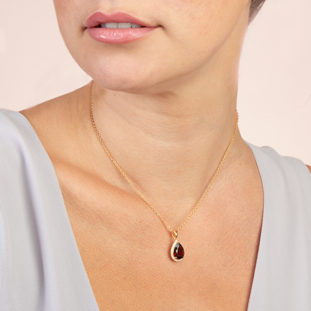 model wearing 18k gold 925 sterling silver pear drop garnet necklace