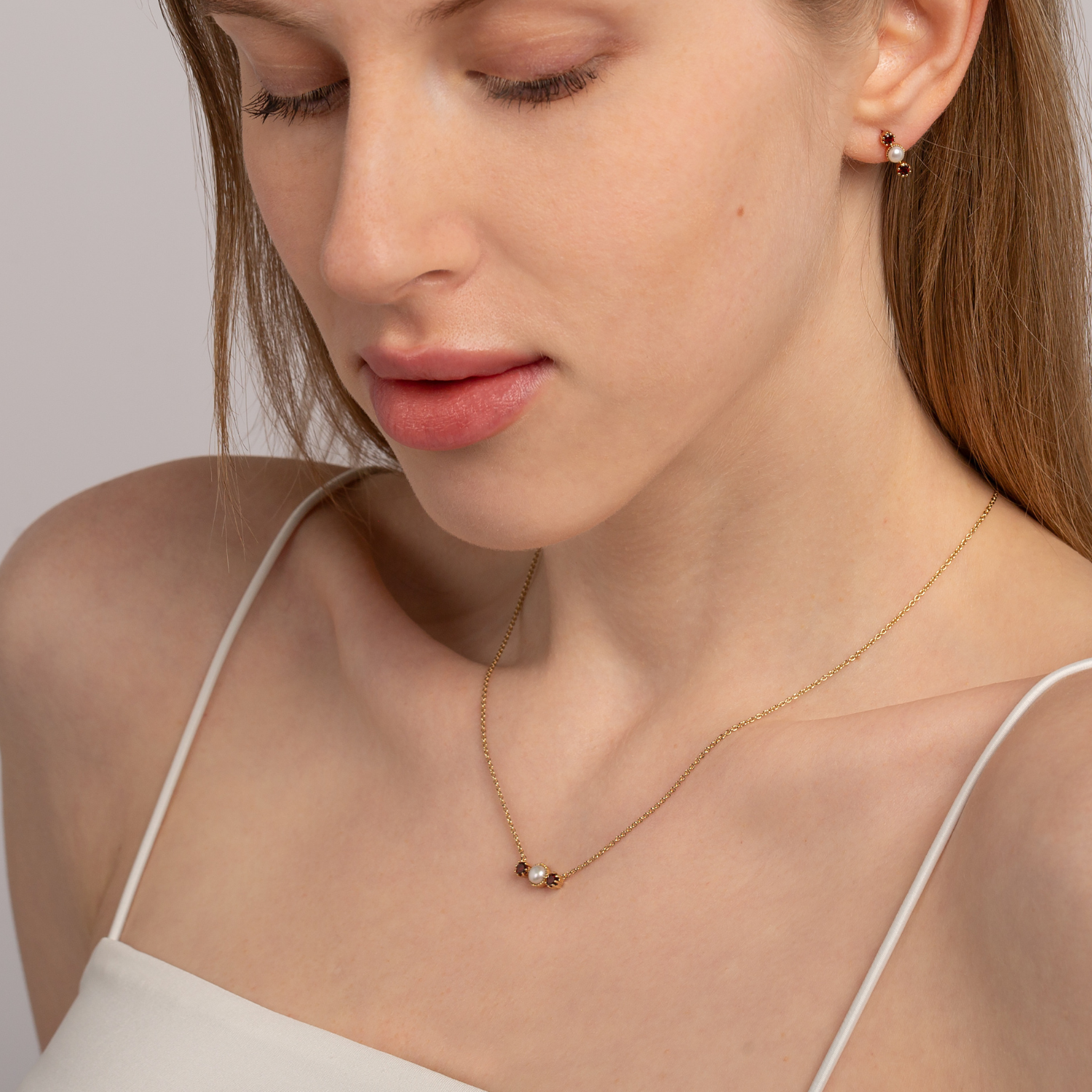 model wearing 18k gold 925 sterling silver garnet pearl necklace