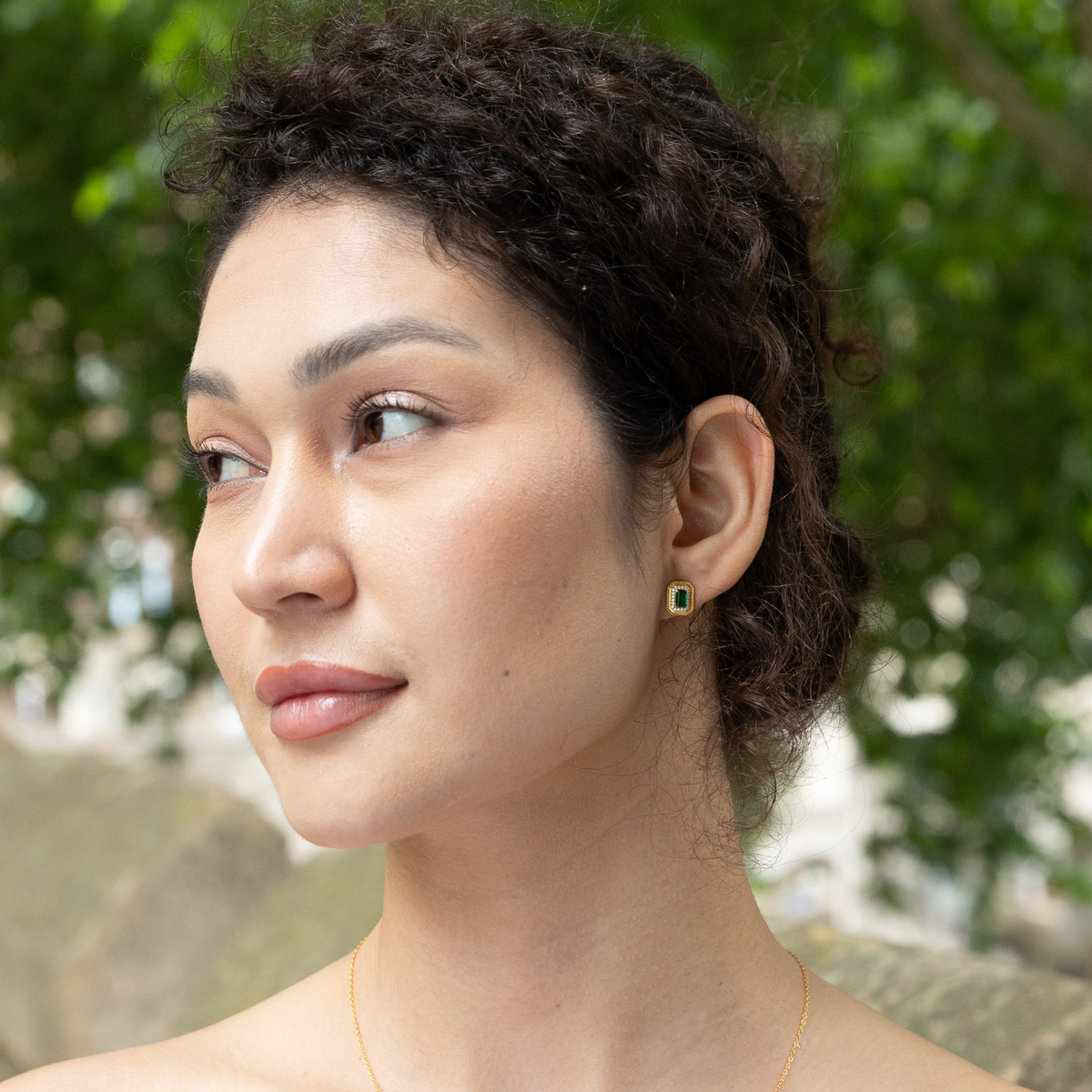 model wearing 18k gold plated sterling silver moissanite stud earrings
