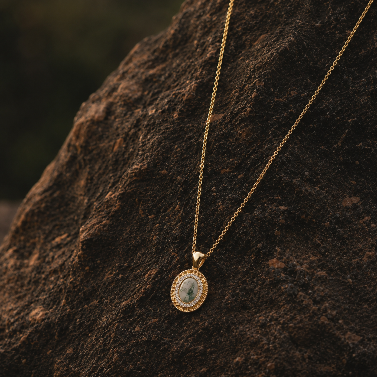 18k gold plated sterling silver moss agate oval necklace on rock