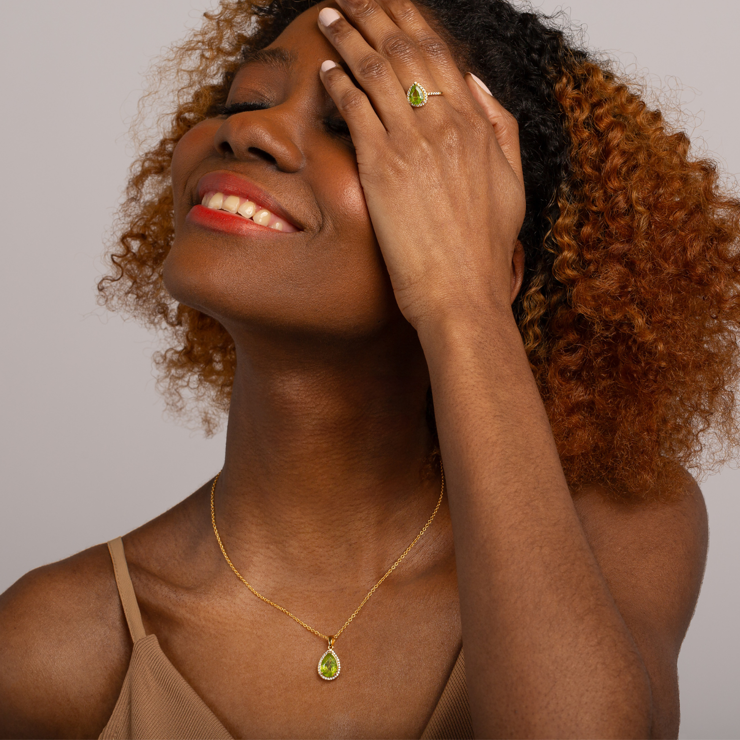 model wearing 18k gold 925 sterling silver pear drop peridot necklace