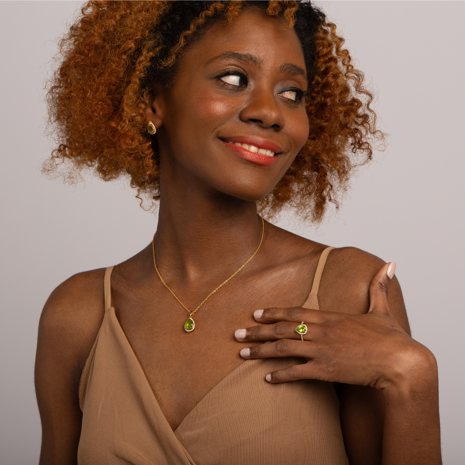 model wearing 18k gold 925 sterling silver pear drop peridot ring