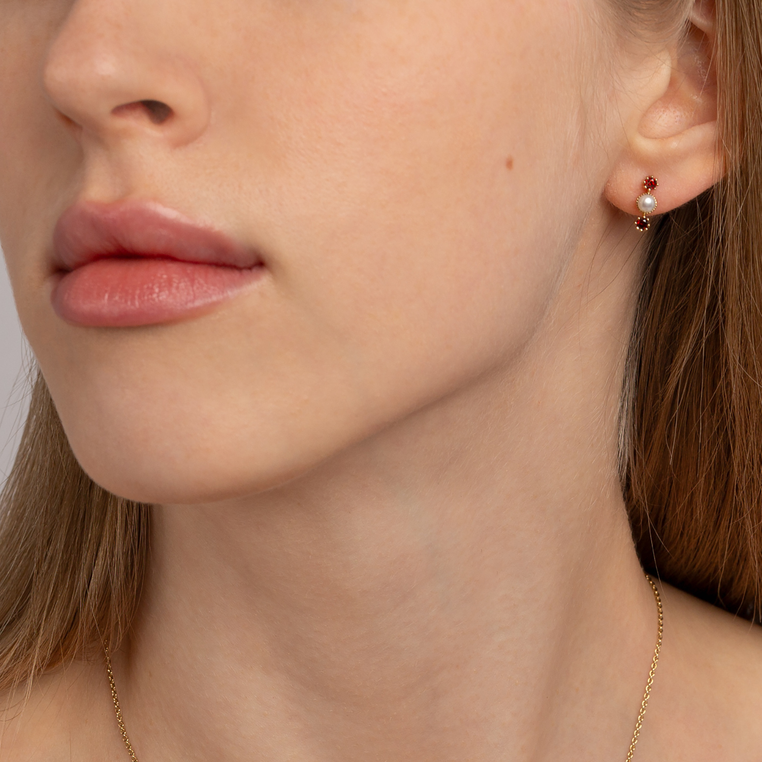 model wearing 18k gold plated 925 sterling silver garnet pearl stud earrings