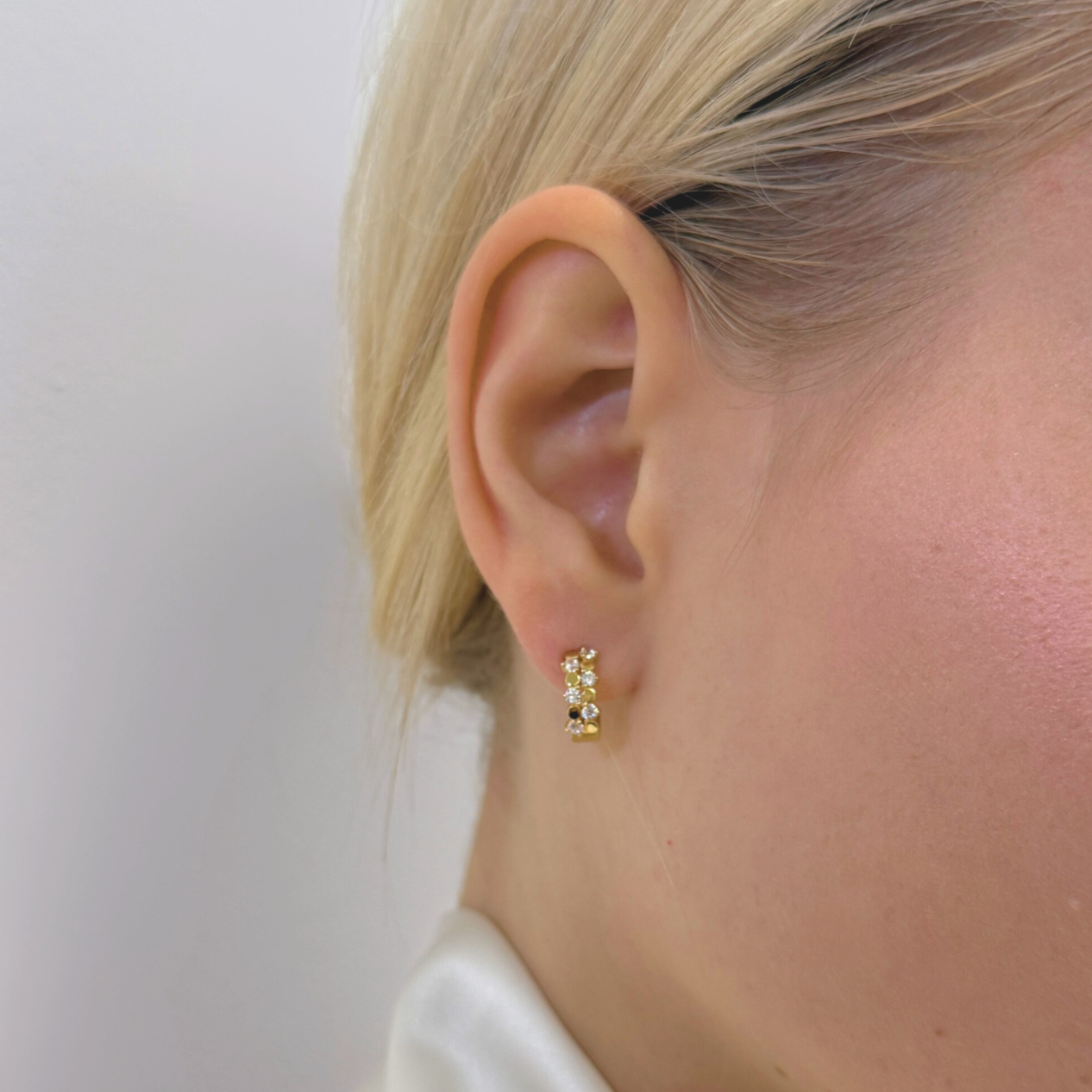 model wearing 18k gold round mini hoops