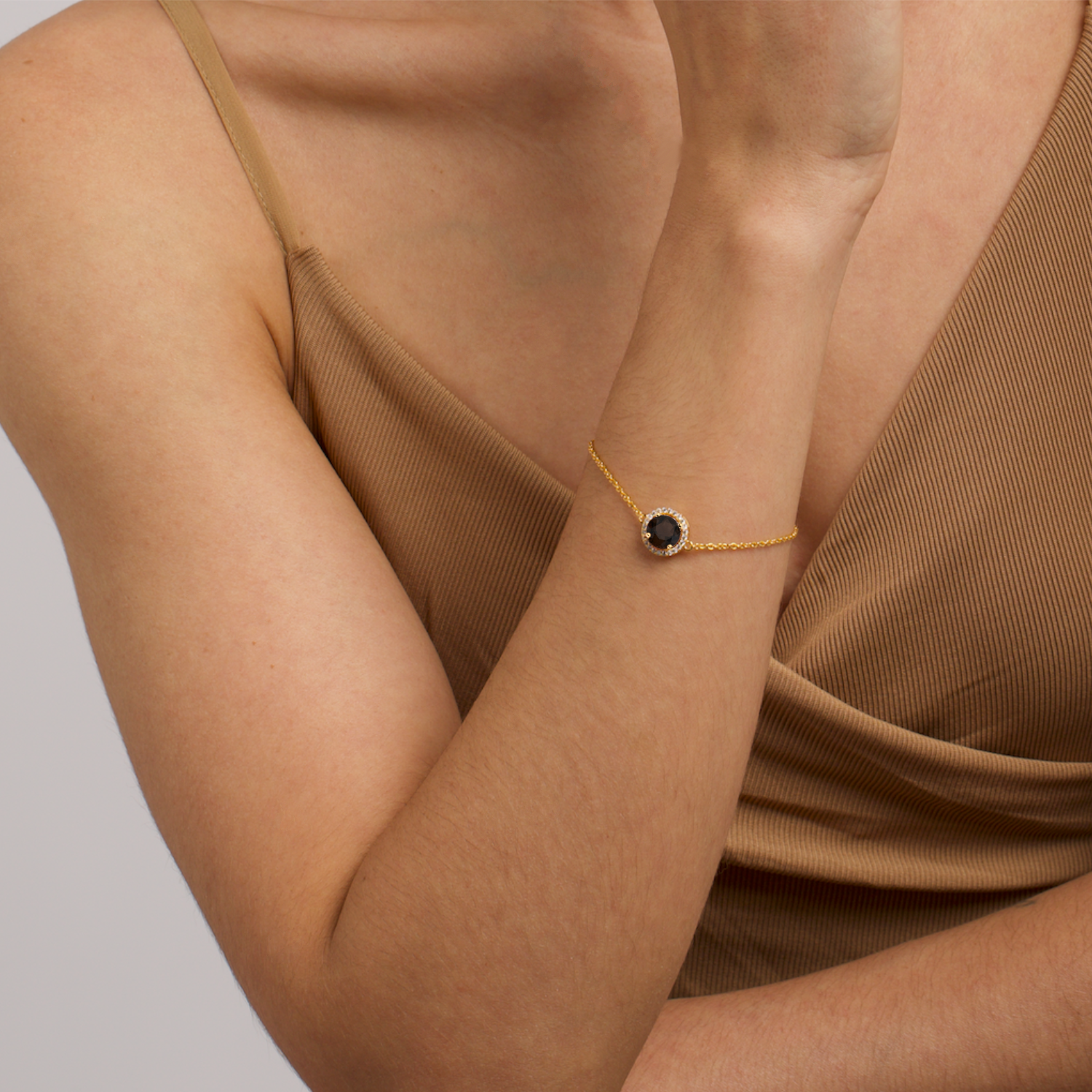 model wearing 18k gold 925 sterling silver smoky quartz gemstone bracelet