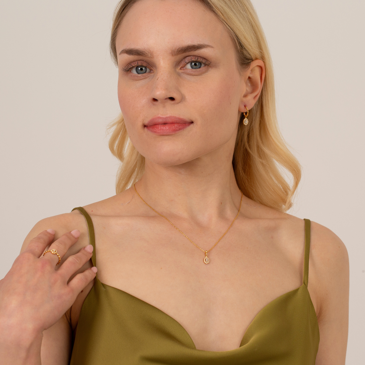 model wearing 18k gold plated sterling silver cubic zirconia ring necklace and earrings