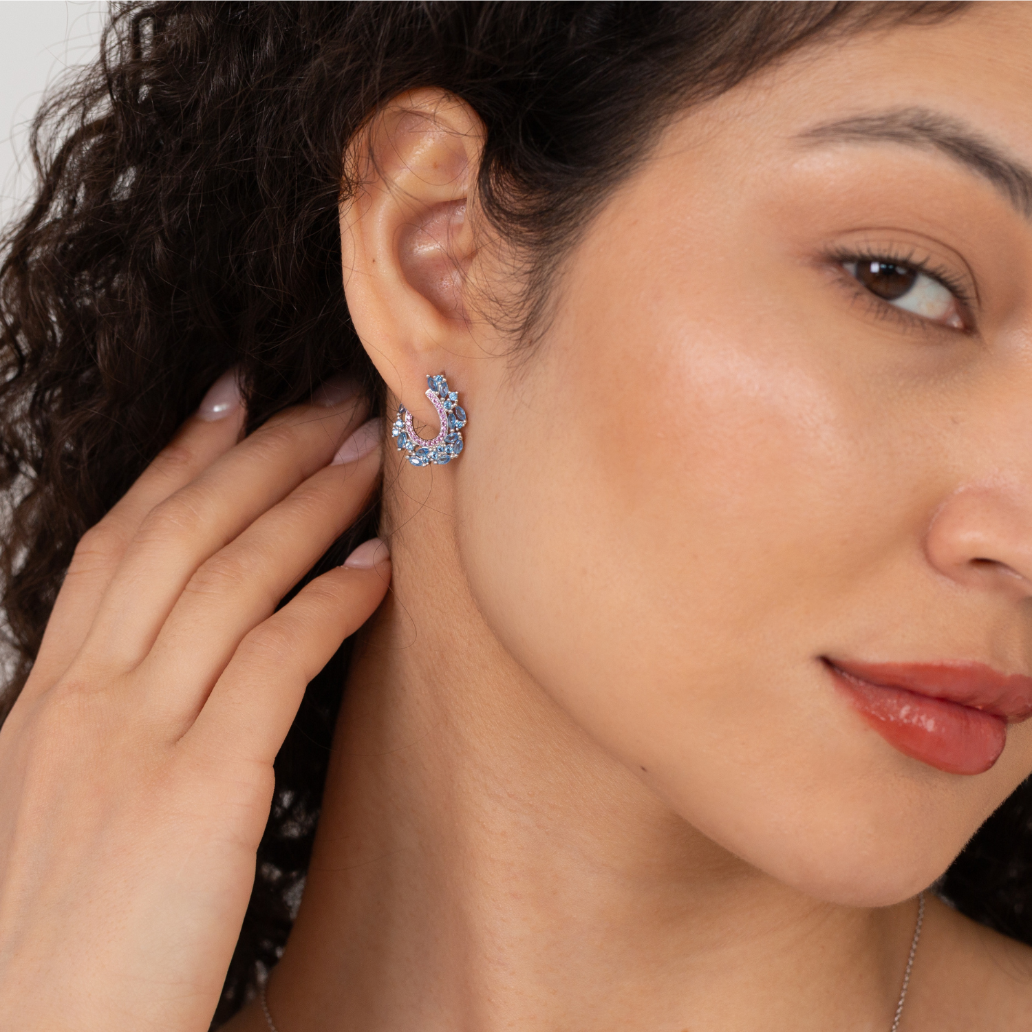model wearing 925 sterling silver blue and pink cubic zirconia earrings
