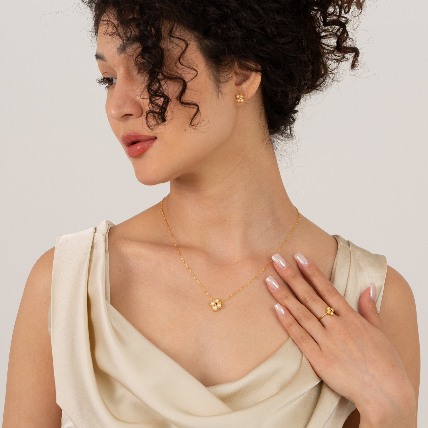 model wearing 18k gold plated sterling silver pearl garnet jewellery set
