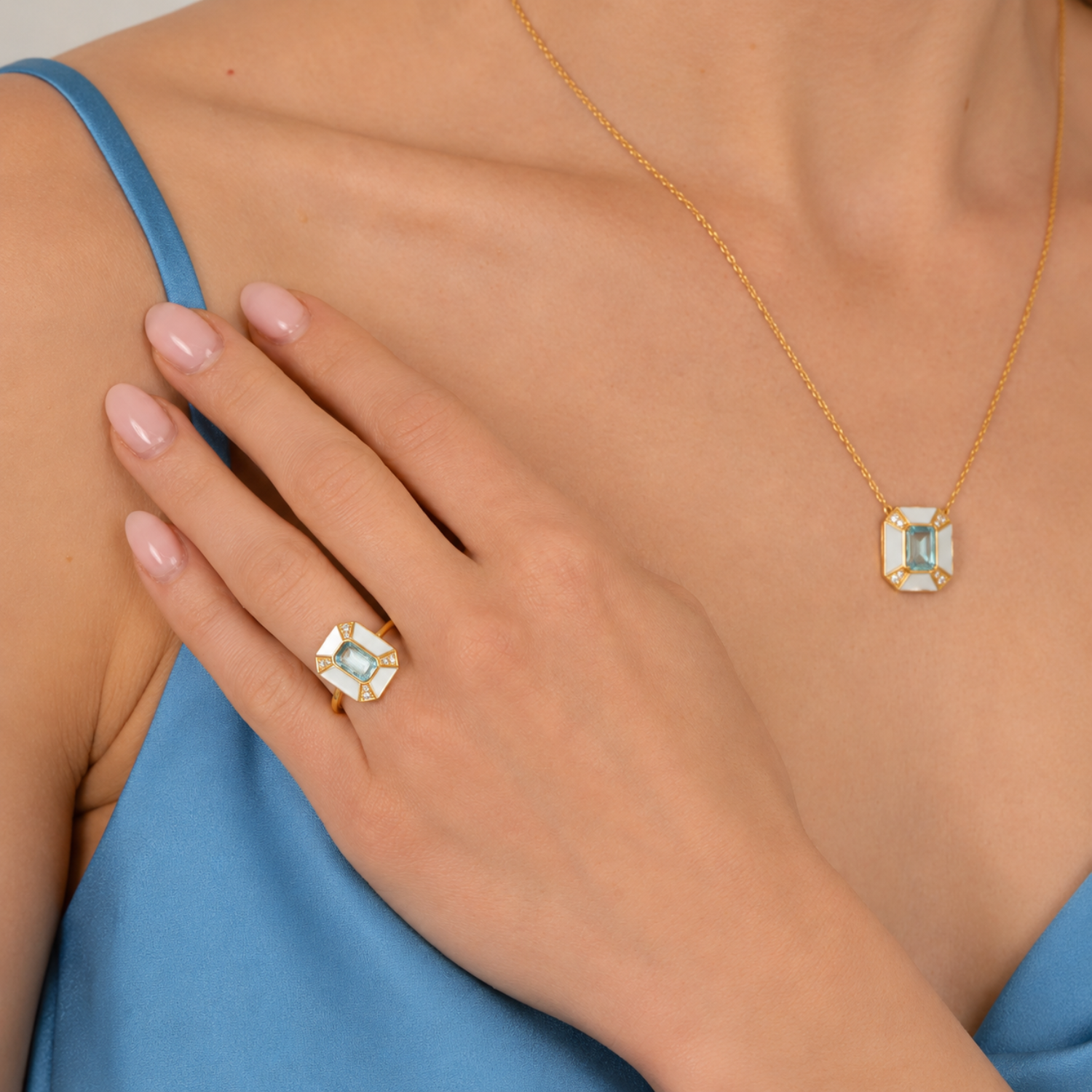 model wearing 18k gold plated sterling silver pearl blue topaz aphrodite jewellery set