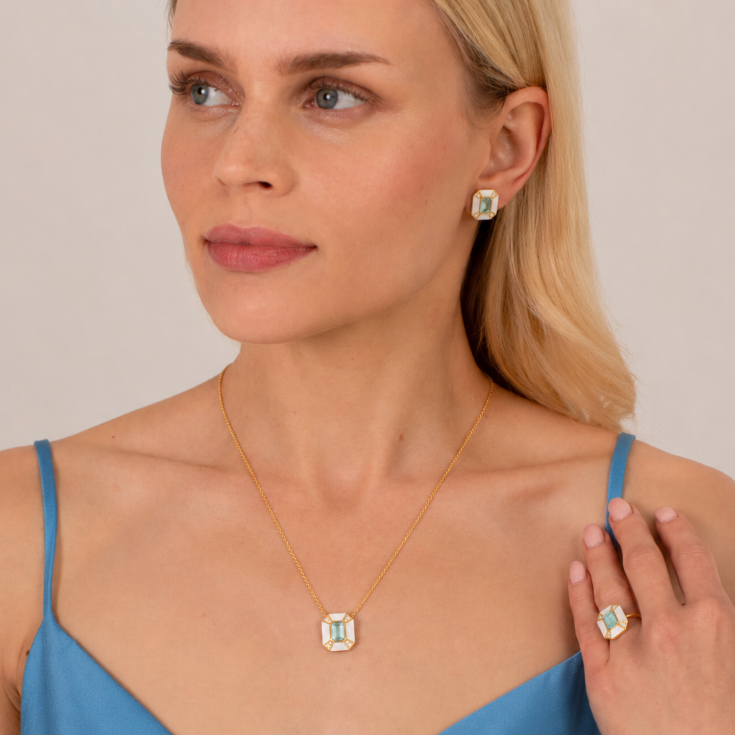 model wearing 18k gold plated sterling silver pearl blue topaz aphrodite jewellery set