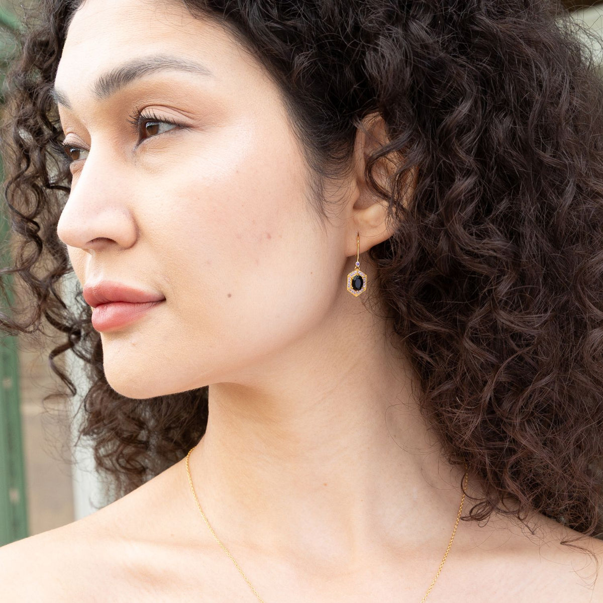 model wearing 18k gold plated sterling silver black agate earrings