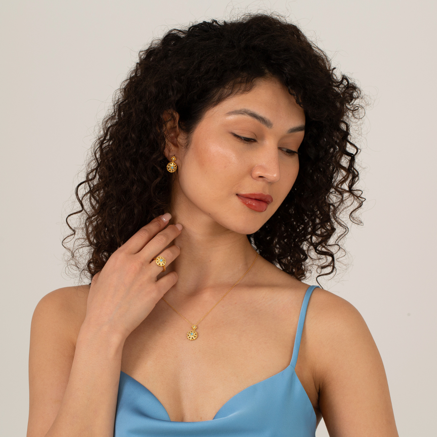 model wearing 18k gold plated sterling silver blue larimar jewellery set